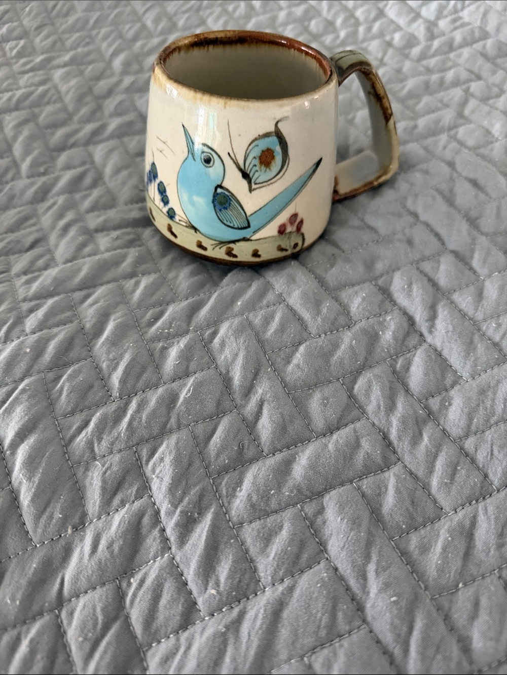 Ken Edward’s Tonala Hand-Painted Blue Bird Ceramic Coffee Mug - Cream Base